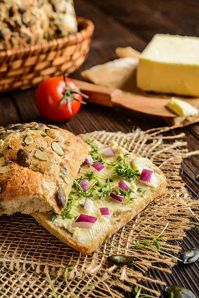 istock Whole grain rolls with butter, onion and cress 611632490