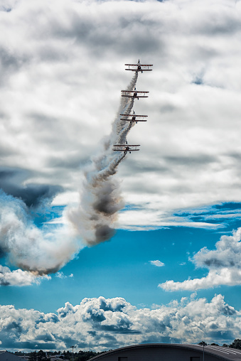 Farnborough, England - July 17, 2016: The Breitling Wingwalkers display team perform at the Farnborough airshow. The team fly 1940s vintage Boeing Stearman biplanes.