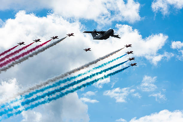 Farnborough, England - July 17, 2016: The Red Arrows and the Airbus A400M in formation for  a fly past at the 2016 Farnborough Air show.