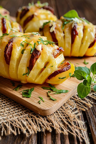 istock Baked potatoes stuffed with sausage, cheese, garlic and herbs 611633648