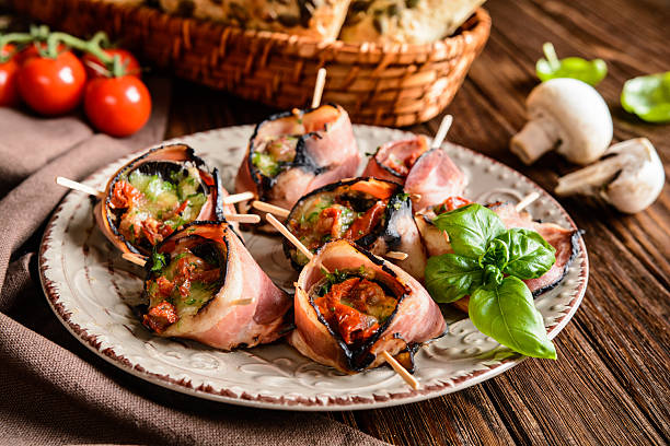 istock Mushrooms stuffed with cheese, sun dried tomatoes wrapped in bacon 611634124