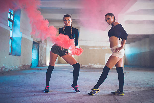istock Beautiful dancers in pink smoke 611634386