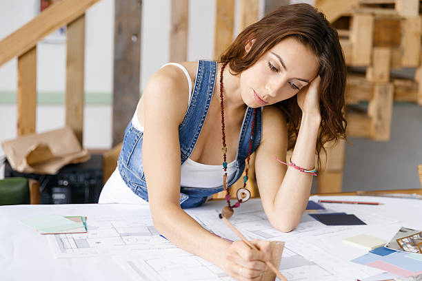 istock Young pretty woman at her desk 611634654