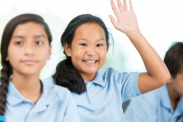 istock Asian schoolgirl excited to answer question in class 611634926