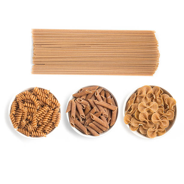 wholemeal pasta. spaghetti, penne and fusilli - whole wheat imagens e fotografias de stock