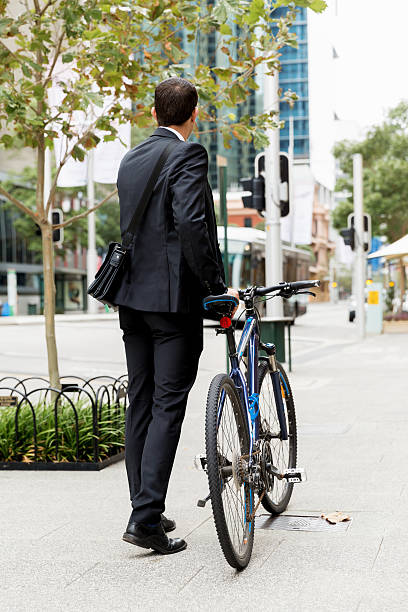 istock Young businessmen with a bike 611745356