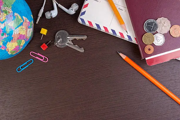 Photo of Top view travel items on the wooden for  travel trip.