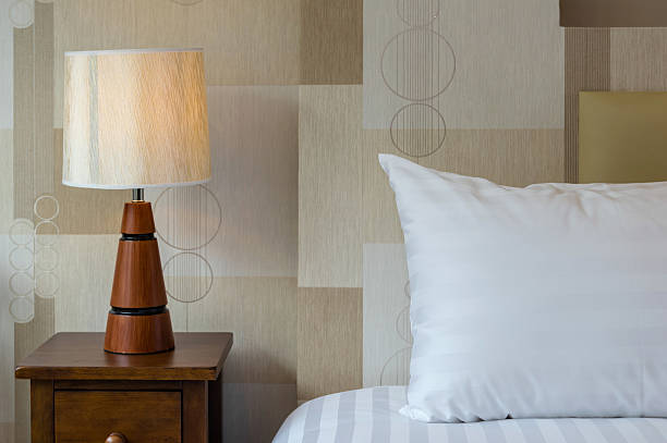 istock Closeup pillow on the bed with lamp in luxury hotel 611747398