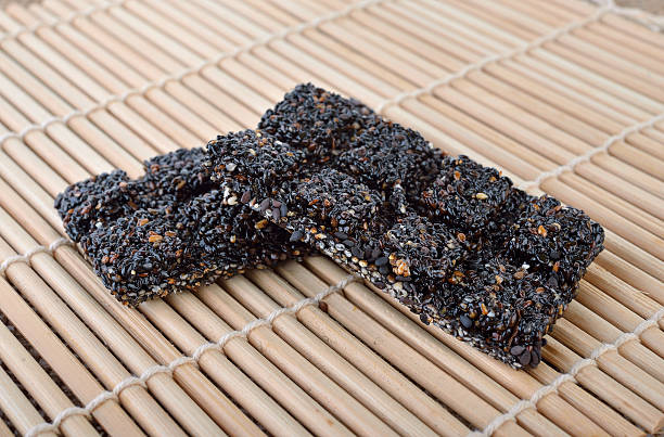 istock sweetened black sesame bar on bamboo mat 611748850