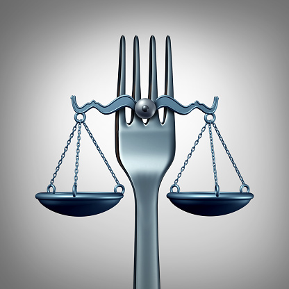 Food law and legal regulations concept with a kitchen fork shaped as a scale of justice as a symbol for nutrition inspection or eating legislation rules as a 3D illustration.
