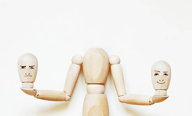 istock Headless man holds two heads with different emotions 611753284