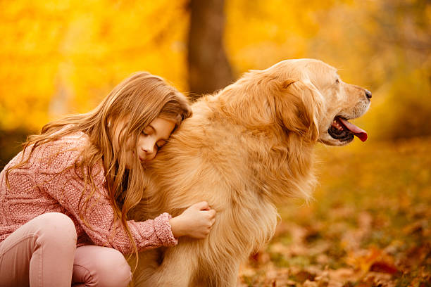 istock Girl embracing dog 611753316