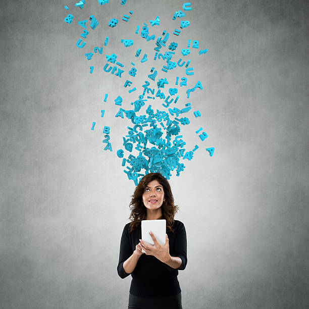 Businesswoman using digital tablet with flying alphabets