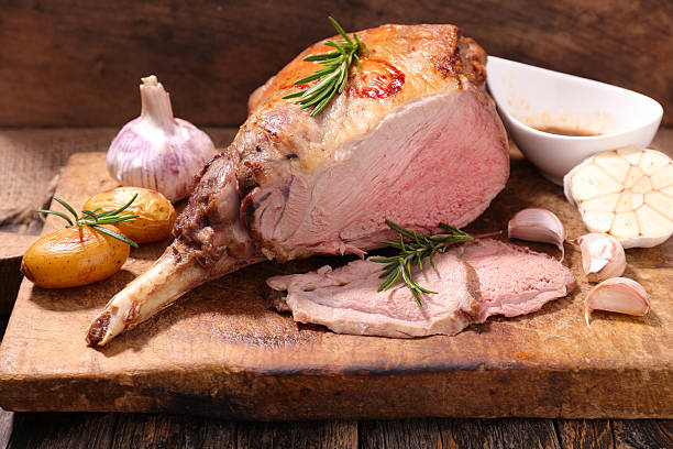 istock roasted lamb leg on wooden board 611758734