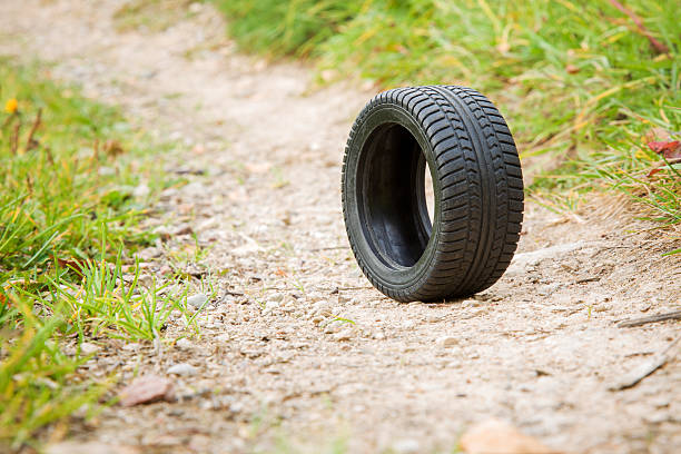istock Black rubber tire rolling on the ground. 611758798