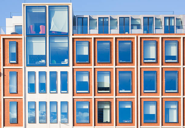 exterior of modern apartment building in red bricks - capital letter luxury blue image imagens e fotografias de stock