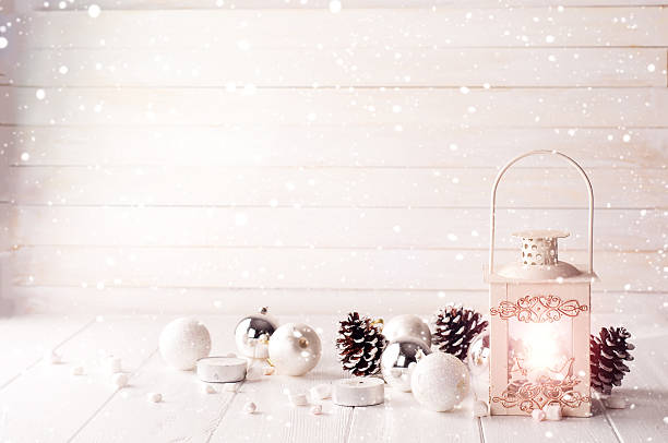 Burning lantern in the snow with christmas decoration