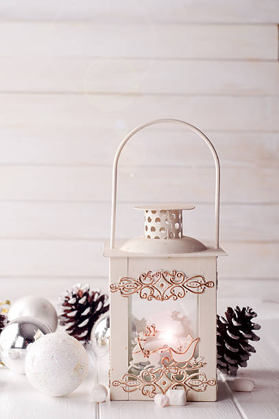 istock Burning lantern in the snow with christmas decoration 611759666