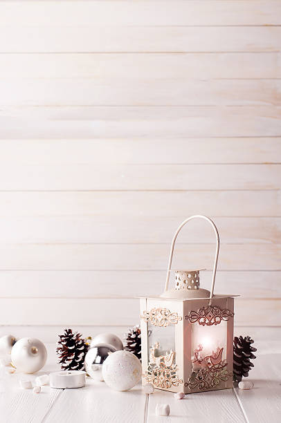 istock Burning lantern in the snow with christmas decoration 611759680