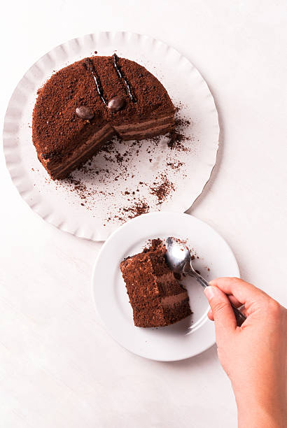 istock Chocolate cake with cream on a white wooden table 611759906