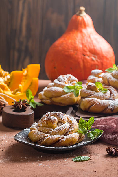 istock Homemade cinnamon buns with pumpkin 611761186