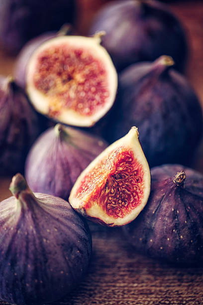 istock Fresh Sweet Figs on Wooden Background 611761564
