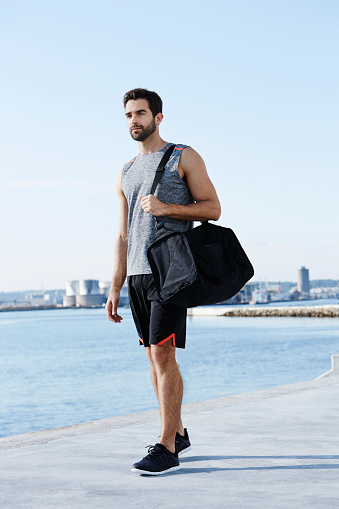 Athlete with sports bag walking
