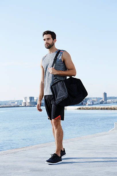 athlete with sports bag - gym bag imagens e fotografias de stock