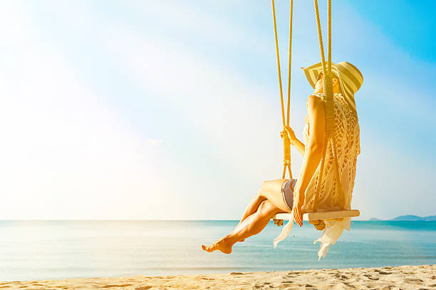 istock Woman at tropical swing 611764436