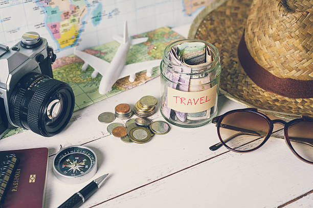 Collecting money for travel with accessories of traveler stock photo