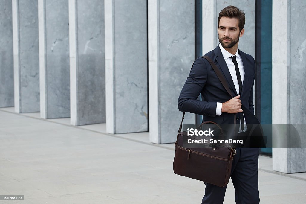 Businessman with briefcase Businessman with briefcase walking in city Men Stock Photo