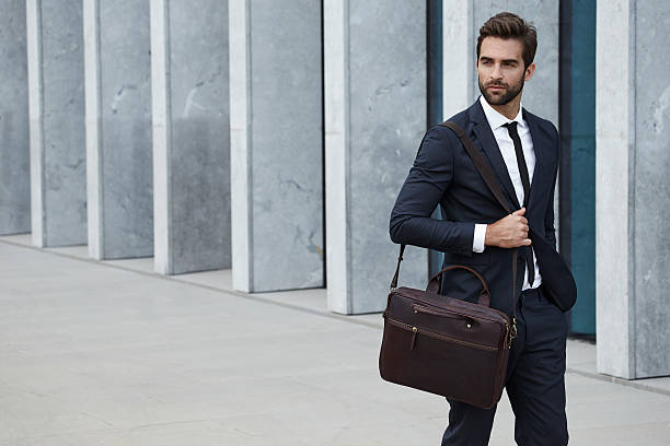 Businessman with briefcase Businessman with briefcase walking in city well dressed stock pictures, royalty-free photos & images