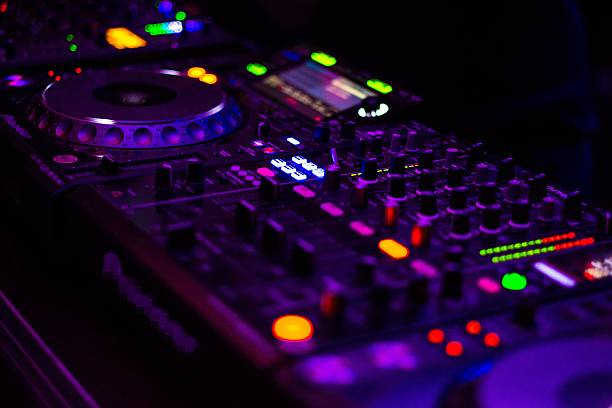 DJ equipment mixing board. Dj dials lit up lights. synthpop stock pictures, royalty-free photos & images