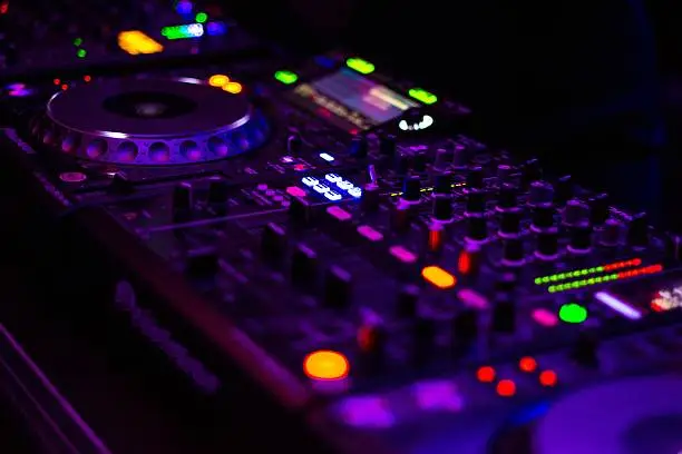 Photo of DJ equipment mixing board.