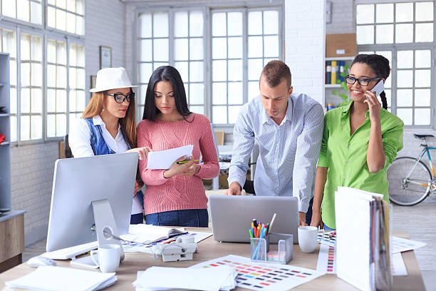 istock Young designers team discussing new project at office 611771504