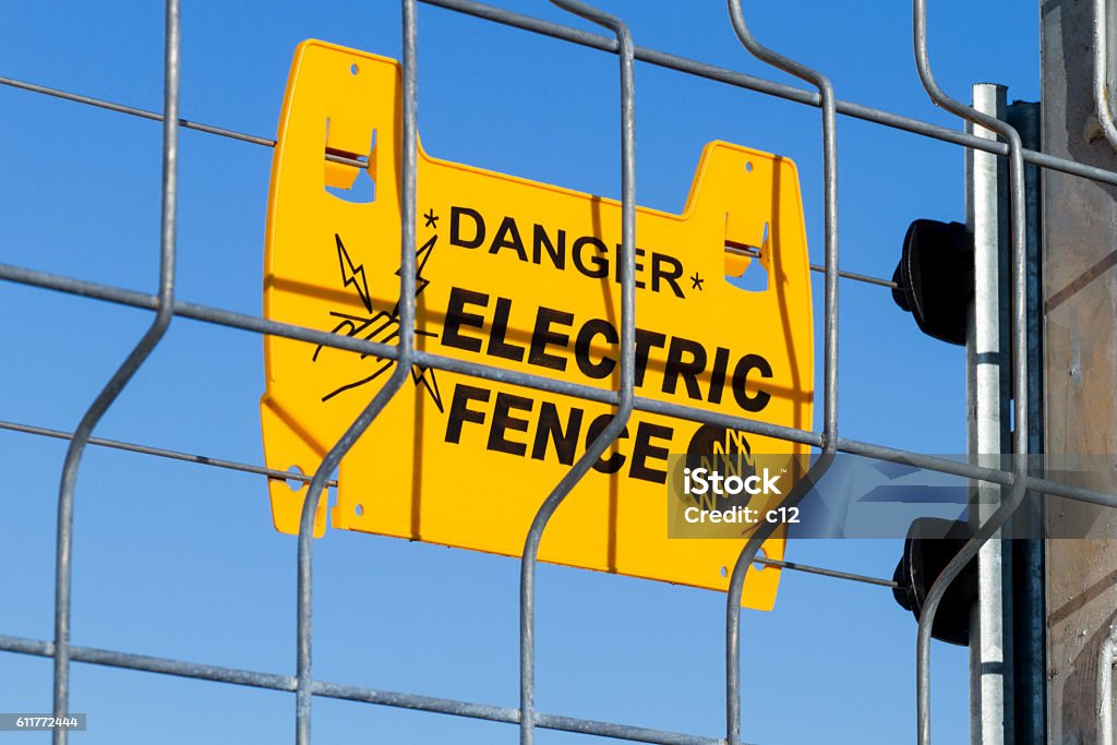 electric fence danger, electric fence Blue Stock Photo