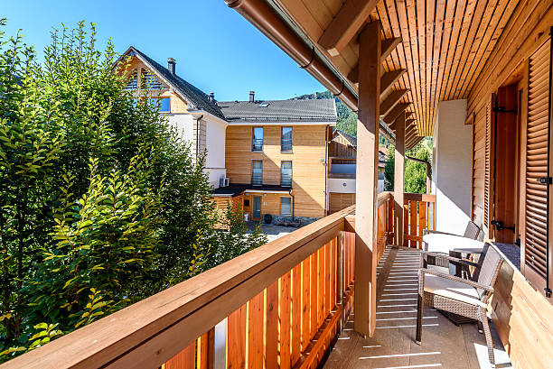 istock Modern wooden terrace - balcony with table and chairs. 611772490