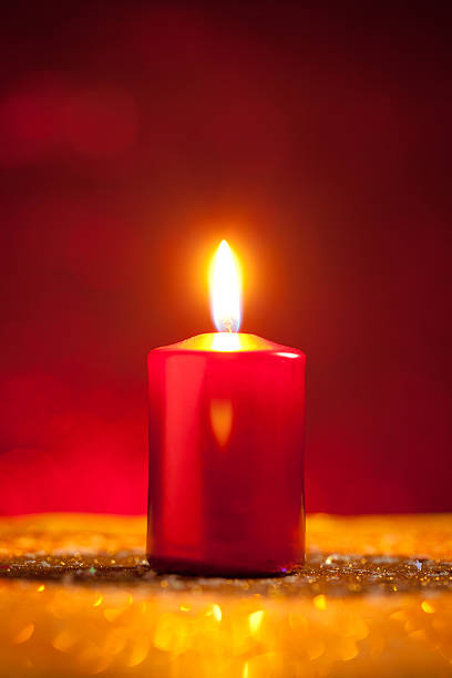 istock Candle on gold glitter with dark red background 611772970