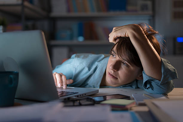 istock Sleepy woman working with her laptop 611772994