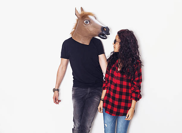 uomo testa di cavallo e bella ragazza che si guardano l'un l'altro - horse men animal head bizarre foto e immagini stock