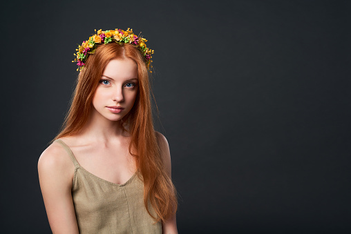 Closeup of beautiful red haired woman in flower wreath