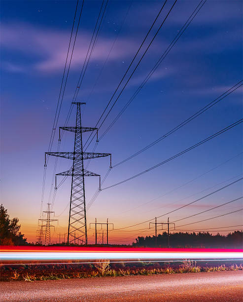 istock High voltage power lines with electricity pylons at twilight. 611774632