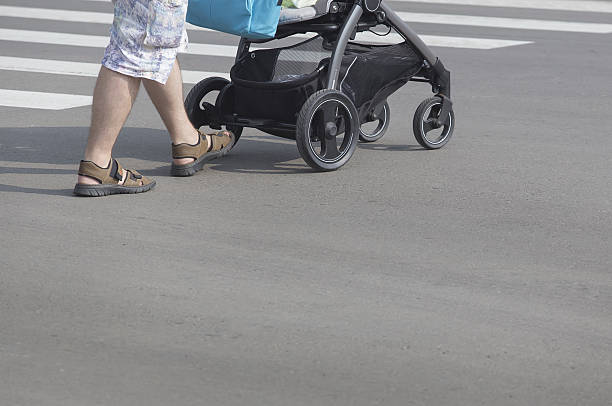 istock man with baby carriage 611774948