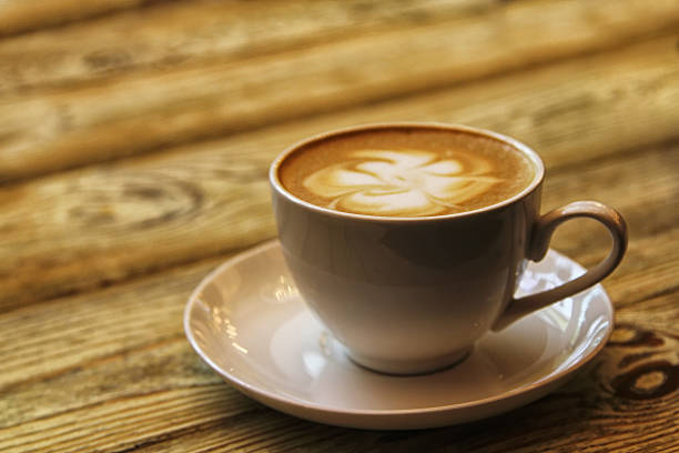 istock Coffee cup with cappuccino on old wooden background 611775830