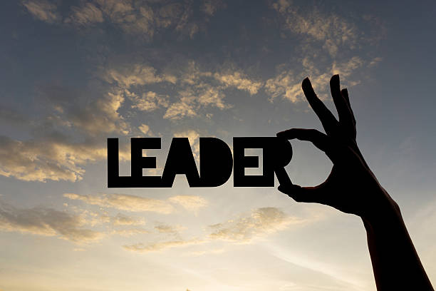 istock Leader word being held against sky 611775916