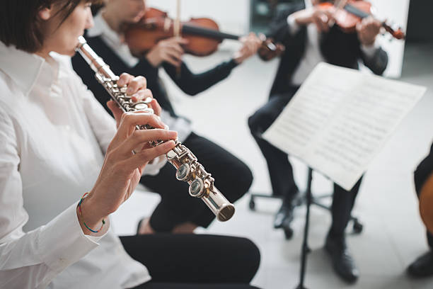 istock Flutist playing her instrument on stage 611778334