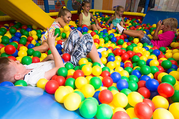 istock Group of kids playing on playground with plastic balls 611778860
