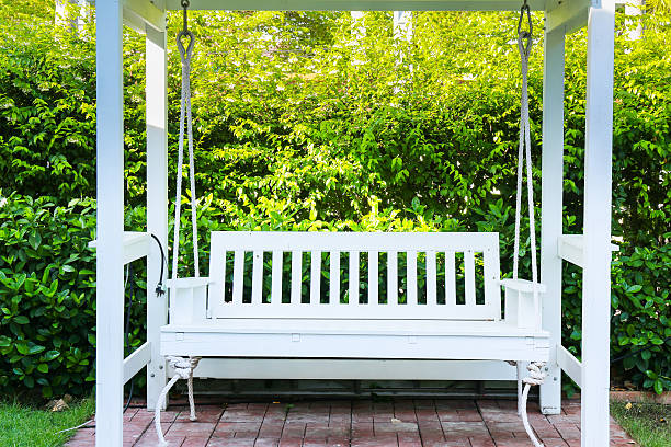 istock White bench in the garden 611779032