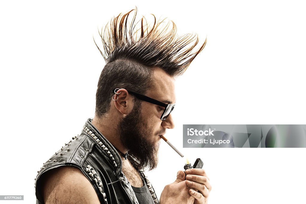 Punker lighting up a cigarette Punker lighting up a cigarette isolated on white background Cut Out Stock Photo