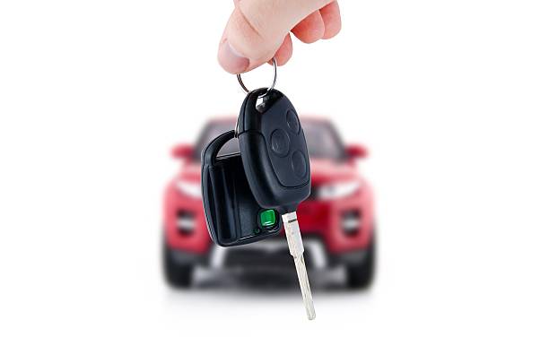 Hand holding keys to new car Hand holding keys to new red car. Buy or selling business composition car key photos stock pictures, royalty-free photos & images